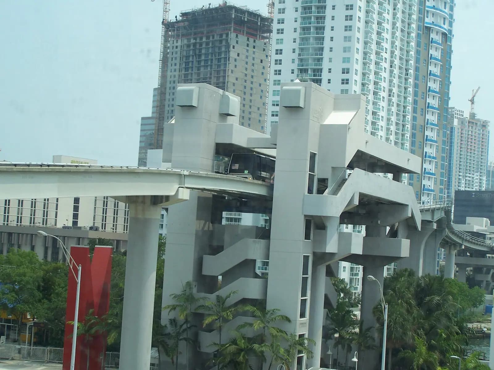 The elevated Riverwalk Metromover station and its concrete guideway between downtown Miami towers