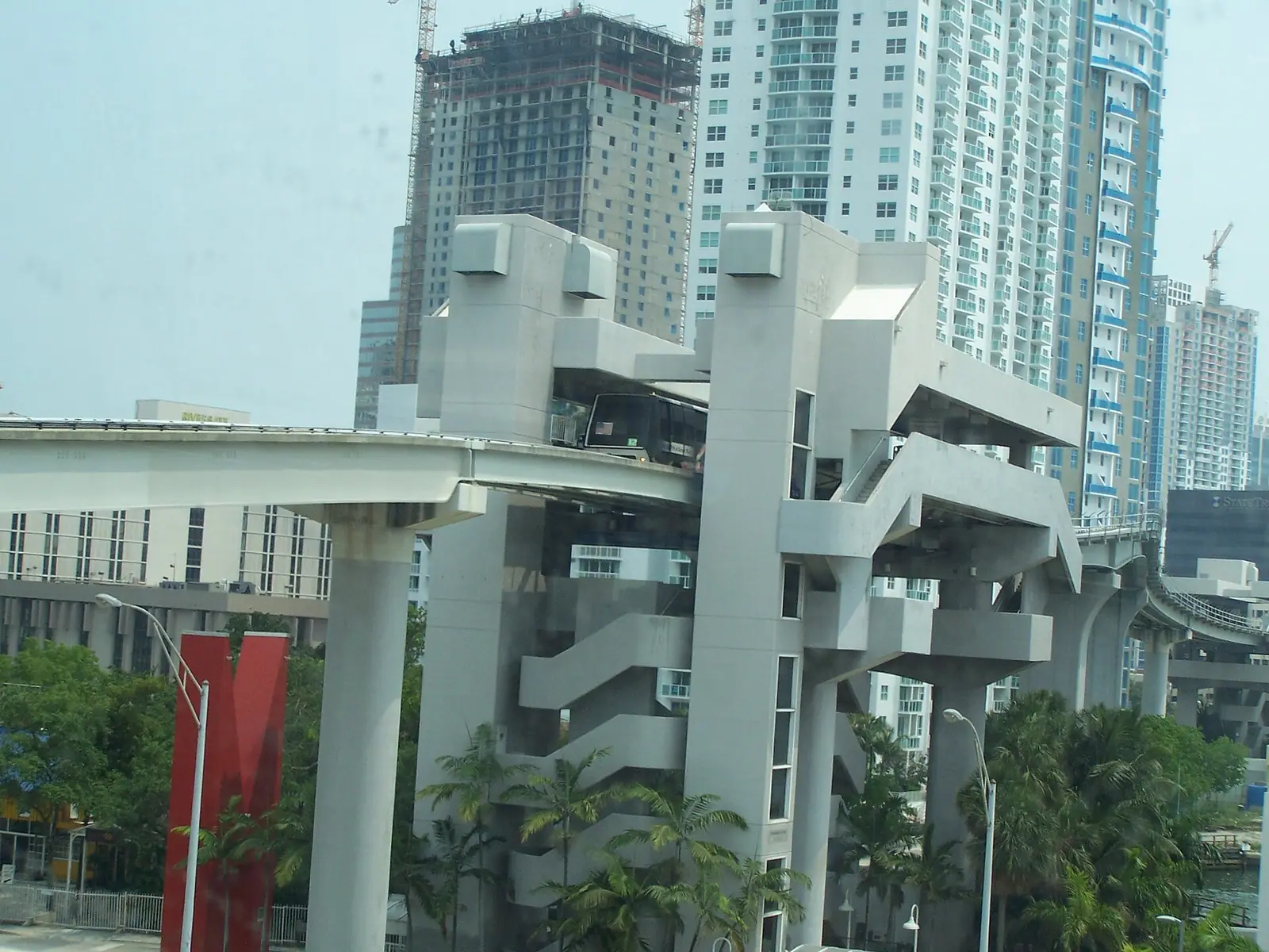 The elevated Riverwalk Metromover station and its concrete guideway between downtown Miami towers